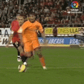 a soccer game is being played on a field with a sign that says iberia via