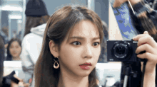 a woman is taking a picture of herself with a camera that says sony on it