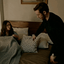 a man and a woman are laying on a bed