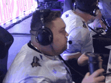 a man wearing headphones and a white shirt with monsters on the sleeves