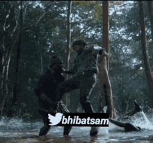 two men are fighting in the water with a twitter logo on the bottom right