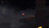 a person is holding a gun in front of a building with a lot of fire coming out of it