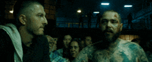 a man with a beard has a tattoo on his chest