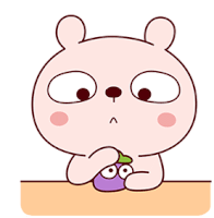 a cartoon rabbit is sitting at a table with a purple fruit in its hands .