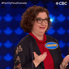 a woman wearing a name tag that says christine is clapping