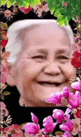 a picture of an elderly woman surrounded by pink and red flowers