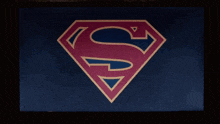 a red and blue superman logo on a black background