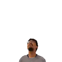 a man with glasses is looking up at a green x on his head