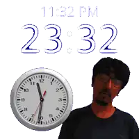 a man stands in front of a clock that says 21:32