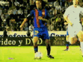 a soccer player with the number 10 on his jersey is dribbling the ball