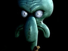 squidward from spongebob squarepants is looking at the camera with a very angry face .