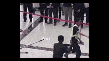 a man standing in front of a crowd with the words " you " on the bottom right