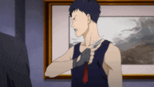 a man in a blue tank top holds a knife to his chest