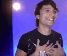 a young man with a ring on his finger is smiling