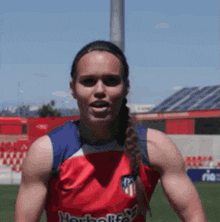 a female athlete wearing a red herbalife jersey