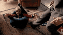 a person laying on the floor with their legs crossed and their tongue out