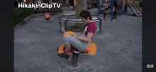a man sits on a rocking horse in a park with the hashtag hiakincliptv at the top