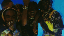 a group of men are dancing in front of a blue background that says ' nirvana ' on it