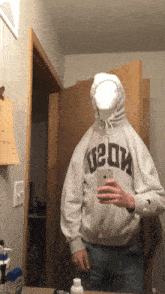 a person wearing a hoodie that says u2dm taking a selfie