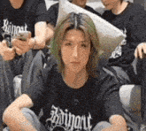 a man with green hair is wearing a black shirt that says boingart on it