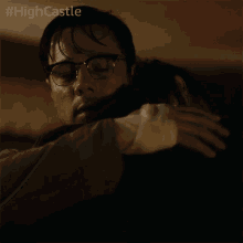 a man hugging another man with the hashtag #highcastle on the bottom