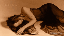 a woman is laying down with the words god 's game written above her