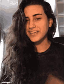 a close up of a woman 's face with the words gifsdayrol below it