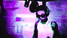 a man wearing headphones and sunglasses is standing in front of a purple wall .