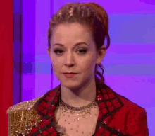 a woman in a red jacket is laughing and smiling .