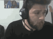 a man with a beard wearing headphones with a microphone