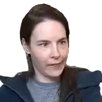 a close up of a woman 's face with a gray shirt and a blue jacket