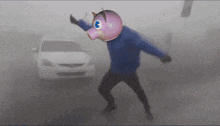 a man wearing a pig mask stands in front of a car in the fog