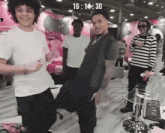 a group of young men are dancing in a room with a sign that says ' lead the way ' on it