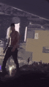 a man without a shirt is standing on a stage