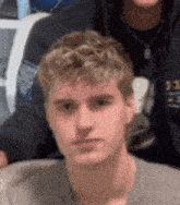 a close up of a young man 's face with a blurry background
