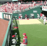 a baseball game is being played in front of a crowd with a sign that says ' king ' on it
