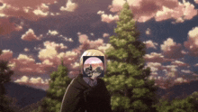 a man in a cape stands in front of trees with a picture of a man in a wheelchair on his head