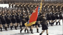 a group of soldiers marching in a parade with a flag that says ' lg ' on it