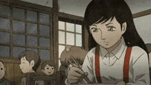 a girl in a white shirt and red suspenders is sitting at a table with chopsticks