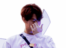 a person covering their nose with their hand and a sticker that says melochoi on it