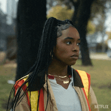 a woman wearing a safety vest and a necklace with the name barbie on it