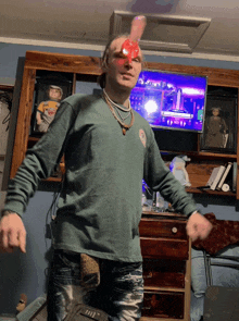 a man in a green shirt has a red balloon on his head