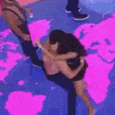 a woman is kneeling down in front of a pink world map