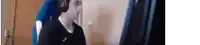 a blurry picture of a person wearing headphones standing in front of a wall .