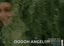 a woman is smiling while standing in front of a tree and says oooh angel .