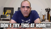 a man in a blue shirt says " do n't try this at home !!! "