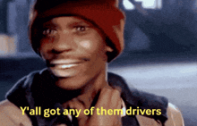 a man wearing a red beanie is smiling and says y 'all got any of them drivers