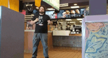 a man in a black shirt stands in front of a mcdonalds counter