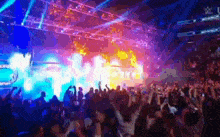 a crowd of people at a concert with the letter w on the bottom right