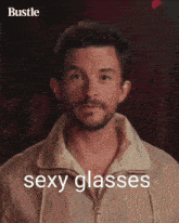 a man adjusts his glasses with the words sexy glasses behind him